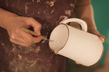 Pottery artist making a shape from clay. Shallow DOF. Developed from RAW; retouched with special...