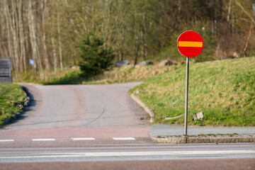 No entry traffic sign at rural roadside.