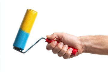 Hand gripping a paint roller with fresh yellow and blue color for home renovation on a white background