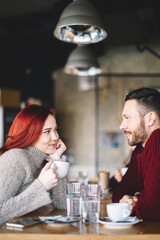 Couple at coffee shop talking and having coffee