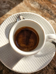 A cup of coffee isolated on the background, top view.