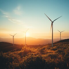 Obraz premium Wind turbines at sunrise over hills