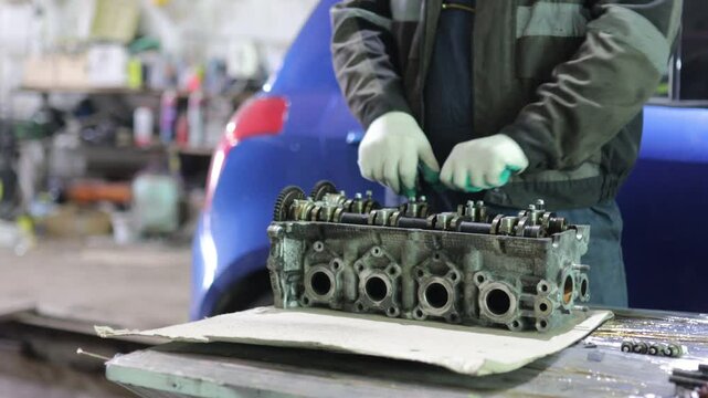 cylinder head repair in car service, camshaft and valve repair