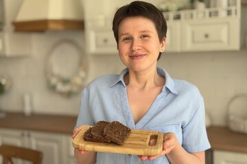 beautiful modern woman baked bread in the kitchen