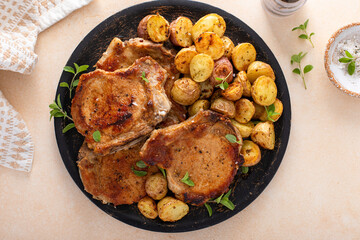 Pork chops on a bone grilled or sauteed served with roasted potatoes