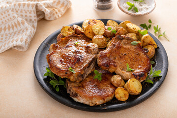 Pork chops on a bone grilled or sauteed served with roasted potatoes
