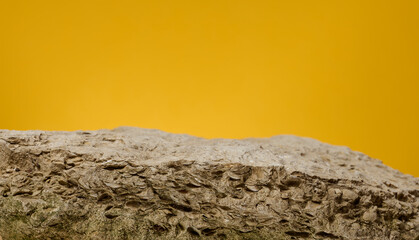 Stones on yellow background, stage for advertising and product demonstration