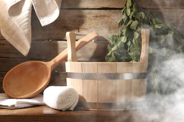 Sauna equipment. Bucket, ladle, whisk and towels in steam