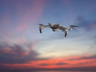 Drone with camera flying in sky. Unmanned aerial vehicle for surveillance