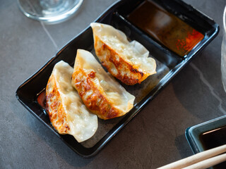 Appetizing japanese gyoza dumplings served with pork served on platter