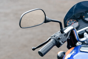 motorcycle rearview mirror on left handlebar handle closeup view