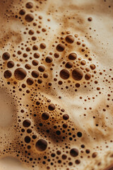 Smooth foamy surface of coffee with soft bubbles. Morning beverage texture concept.

