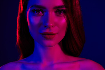 Stunning sensual Woman in Artistic Red and Blue Lighting with Elegant Hair and Glamorous Makeup on Calm Background