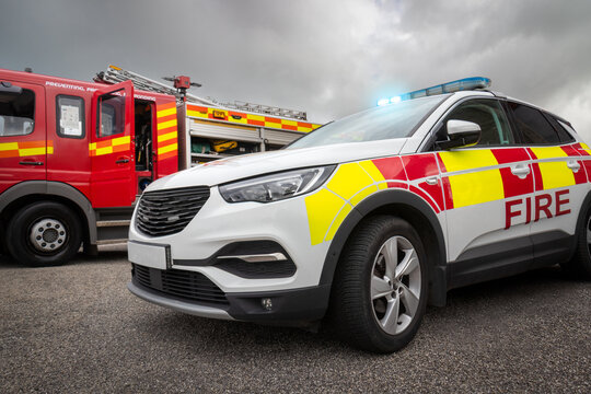 Fire truck and car emergency services vehicles. The fire engines carry ladders, firefighting apparatus and water to save lives, suppress wildfire, extinguish building fires and assist in collisions.
