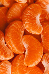 peeled tangerine slices, food background, delicious fruits, useful citrus vitamins concept, pattern, texture, selective focus
