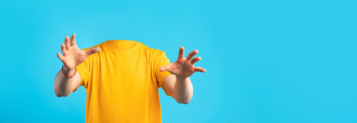 This visual depicts a headless figure in a bright yellow shirt reaching out, showcasing a unique portrayal of lifestyle without conventional identities.
