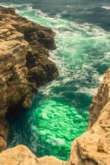 Vibrant Green Ocean Cove Cliffside Aerial View