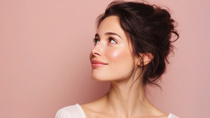 Fototapeta premium Radiant Brunette Model with Glossy Skin Looking Up Against Background