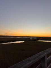 Coastal Marsh at Sunset with Boardwalk Railing View