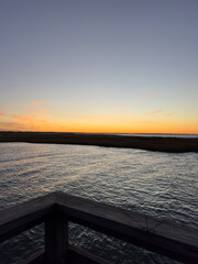 Sunset Over Coastal Marsh Viewed from Wooden Boardwalk