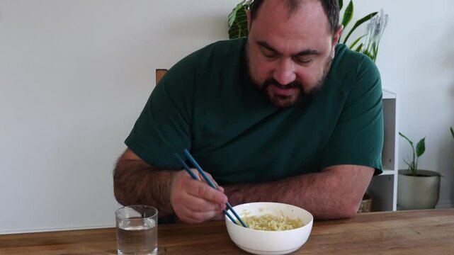 Father and daughter are eating asian food at home