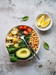 Healthy Buddha Bowl with Fresh Vegetables and Avocado