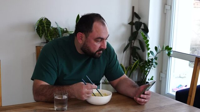 Father and daughter are eating asian food at home