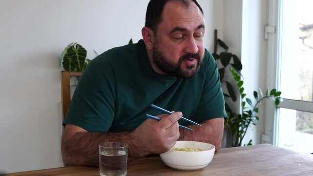 Father and daughter are eating asian food at home
