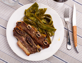 Delicious grilled beef served with green beans on plate