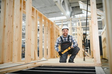 A carpenter works on the construction of modular houses