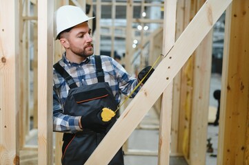 A carpenter works on the construction of modular houses