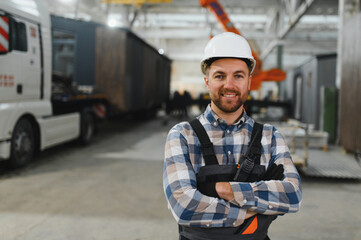 A worker controls the process of loading a modular house onto a truck. Transportation and delivery...
