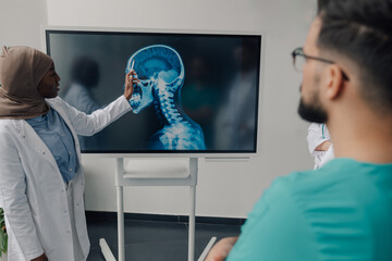 Medical team analyzing skull x ray on digital screen in hospital