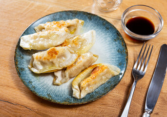 Appetizing japanese gyoza dumplings served with pork served on platter