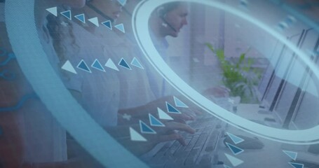 customer service team typing speaking at office desks, featuring digital overlay with glowing rings - Powered by Adobe