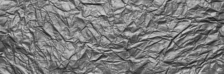 A textured gray crumpled paper background with natural creases and folds. Ideal for design projects, digital graphics, or creative presentations requiring a vibrant, Long banner.