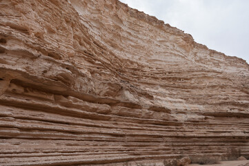 A rocky cliff with a few small rocks scattered around