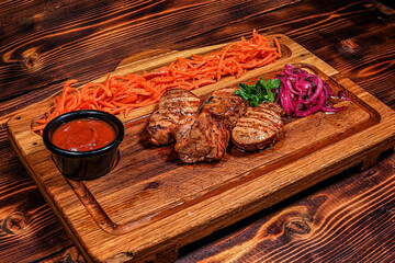 Angled View: Grilled Meat Pieces with Shredded Carrots and Onions on Dublin Irish Pub Board, Dark...