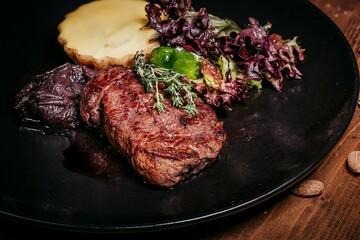 Juicy steak with salad, top view on rustic wooden background