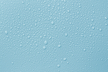 Many water drops on light blue background