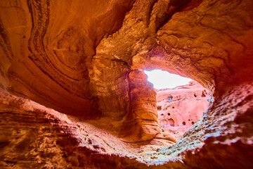 Sandstone Cave View with Sunlit Desert Formations from Inside