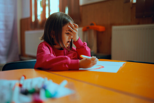 Unhappy Kid Feeling Frustrated with Her Dawning Assignment. Stressed out kid feeling overwhelmed with school tasks 
