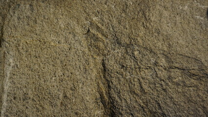 Close-up of rough textured stone surface, showing natural patterns. Use for background or texture