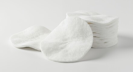 Obraz premium Pristine White Cotton Pads Stacked Elegantly on a Smooth White Surface with Soft Lighting