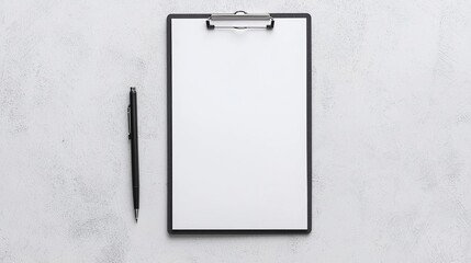 A minimalistic clipboard with a pen placed beside it on a textured gray surface, ideal for note-taking or brainstorming.