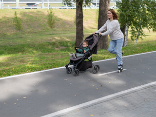 Caucasian woman roller skating with her toddler son in a stroller. 