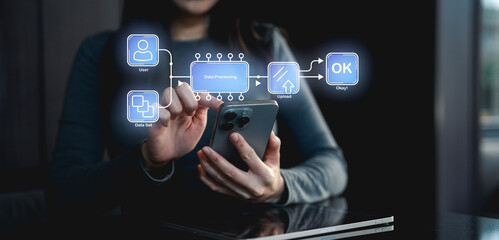 A person interacts with a smartphone displaying data processing flow, emphasizing technology and user interface design.