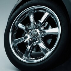 Chrome wheel and tire close up view on white background