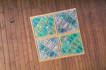 The bottom of a square multicolored crystal chandelier