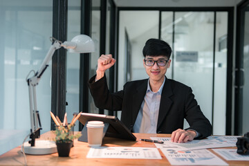 Celebrating success young professional's triumph in modern office environment